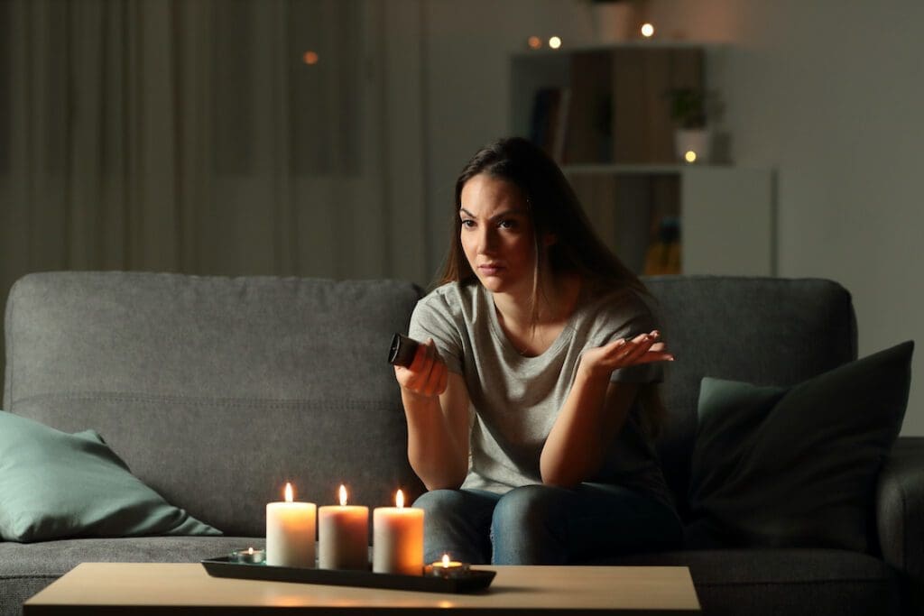 Confused woman watching TV - photo